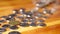 Panning video over an assortment of coins on a wood table.