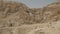 Panning view of the hills and caves containing the dead sea scrolls at qumran