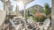 Pano Backyard of a house with a pergola covered patio beside the small door deck