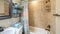 Pano Bathroom interior with antique fixtures and ceramic tile walls