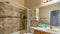 Pano Bathroom interior with bathtub toilet cabinets oval sink and tiles on floor and wall