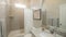 Pano Bathroom interior with vanity and tub with light brown rectangular wall tiles and window