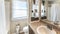 Pano Bathroom interior with window, vanity sink and wood shelves divider with decorative display