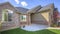 Pano Beautiful exterior of home with brick wall landscaped yard and arched entryway