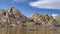Pano Big horn dam reservoir at Joshua Tree National Park against huge rocks and sky