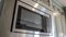 Pano Built in microwave oven and wall cabinets inside the clean kitchen of home