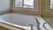 Pano Clean white bathtub with stainless steel faucet built inside bathroom of home