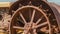 Pano Close up of the damaged wheels of an old vintage tractor against sunny blue sky