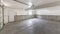 Pano Empty garage interior with concrete floors and an automatic door