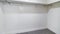 Pano Empty walk in closet with metal hanging rods and wooden shelves