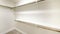 Pano Empty walk-in closet with white walls and carpeted floor
