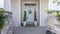 Pano Entrance of a house with decorative light blue front door and posts with stone bricks