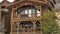 Pano Exterior of cabin in Park City Utah with brown wood exterior wall and balconies