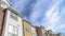 Pano Exterior of houses with dormers and balconies beneath scenic skyscape view