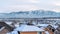 Pano Family houses in a tranquil neighborhood with view of snowy mountain in winter