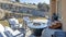 Pano Fire pit and paved patio at sunny backyard of house with stone retaining wall