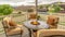 Pano frame Chairs around table with fire pit at a residential balcony framed with railings