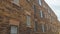 Pano frame Exterior of an old classic building with brick wall and windows with gray frames