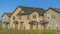 Pano frame Exterior view of multi storey homes with balconies and porticos against blue sky