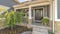 Pano frame Home with landscaped yard stairs porch and front door with sidelight and wreath