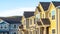 Pano frame Townhouses with gable roof and stairs at the entrance framed by square columns