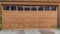 Pano Glass paned brown front door and garage door of house in San Diego California