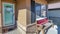 Pano Home entrance with storm door wooden front door open porch and brick wall