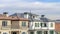 Pano Homes with balconies in Huntington Beach California against clouds and blue sky