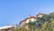 Pano House with beautifully landscaped yard against blue sky in San Diego California