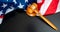 Pano of Judge gavel and striking block on black background and the american national flag.