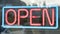 Pano Neon sign of open with red letters and the border as blue.