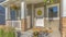 Pano Outdoor stairs porch and white front door with wreath at the facade of a home