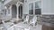 Pano Patio in front of a townhouse with wooden white fence and rocking chairs