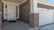 Pano Portico with white front door adjacent to the garage door at the facade of house