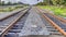 Pano Railway tracks along road against overcast blue sky in San Diego California