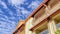 Pano Residential apartment house against vibrant blue sky in Huntington Beach CA
