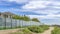 Pano Residential landscape with homes under cloudy blue sky in a seaside neighborhood