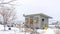 Pano Roofed storage shed with single door on a landscape with snow at winter time