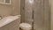 Pano Shower stall with sliding glass door beside toilet and sink on white countertop