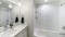 Pano Small modern plain white bathroom with an alcove bathtub with glass wall partition and white tiles