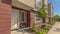 Pano Sunny day view of townhomes with pathways on the yard leading to front doors