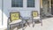 Pano Swing bench and chairs at the open porch of a home viewed on a sunny day