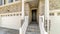 Pano Townhouse entrance with concrete stairs leading to front door under a portico