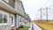 Pano Townhouses exterior view with grassy backyards enclosed in low picket fences