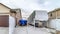 Pano Vehicles at an open parking area beside attached home garage with brown door