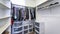 Pano Walk-in closet with plastic wardrobe storage and wall mounted shelves and rods
