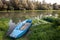 Panorama of an abandoned rowing boat, an blue small boat, resting in the neglected shore of the tamis timis river in Jabuka, in