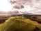Panorama aerial helicopter view over wind farm landscape in Germany with white generator turbines