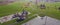 Panorama aerial view empty parking space at community recreational center with playground, huge grassy baseball field and colorful