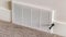 Panorama Air conditioner white plastic grille cover against wall and carpet floor